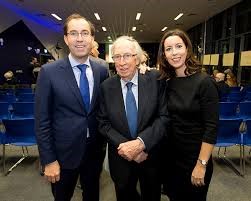 Raymond Kearns, flanked by his son Peter and daughter Una,
					directors of the Institute of Education